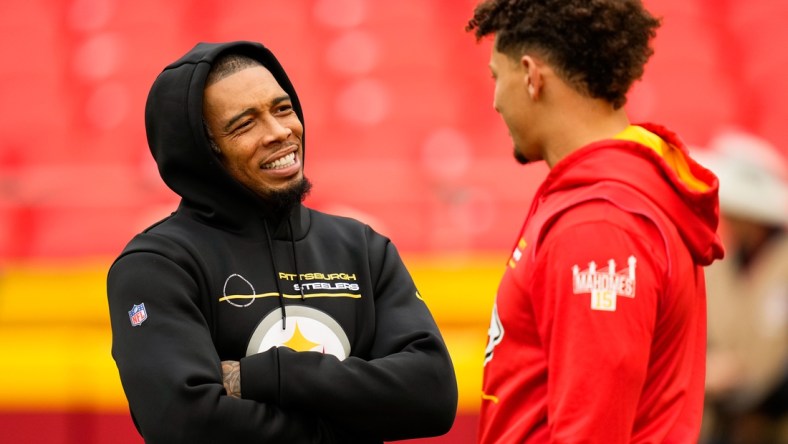 Dec 26, 2021; Kansas City, Missouri, USA; Pittsburgh Steelers cornerback Joe Haden (23) talks with Kansas City Chiefs quarterback Patrick Mahomes (15) before the game at GEHA Field at Arrowhead Stadium. Mandatory Credit: Jay Biggerstaff-USA TODAY Sports