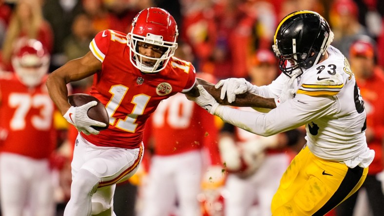 Dec 26, 2021; Kansas City, Missouri, USA; Kansas City Chiefs wide receiver Demarcus Robinson (11) runs the ball against Pittsburgh Steelers inside linebacker Joe Schobert (93) during the second half at GEHA Field at Arrowhead Stadium. Mandatory Credit: Jay Biggerstaff-USA TODAY Sports