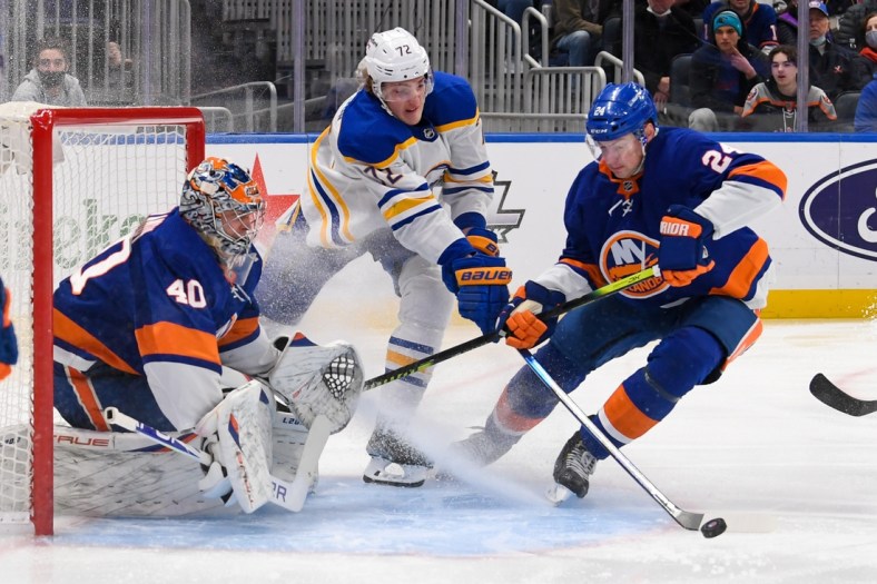 Dec 30, 2021; Elmont, New York, USA; Buffalo Sabres right wing Tage Thompson (72) and New York Islanders defenseman Scott Mayfield (24) scramble for the puck after a save by New York Islanders goaltender Semyon Varlamov (40) during the first period at UBS Arena. Mandatory Credit: Dennis Schneidler-USA TODAY Sports