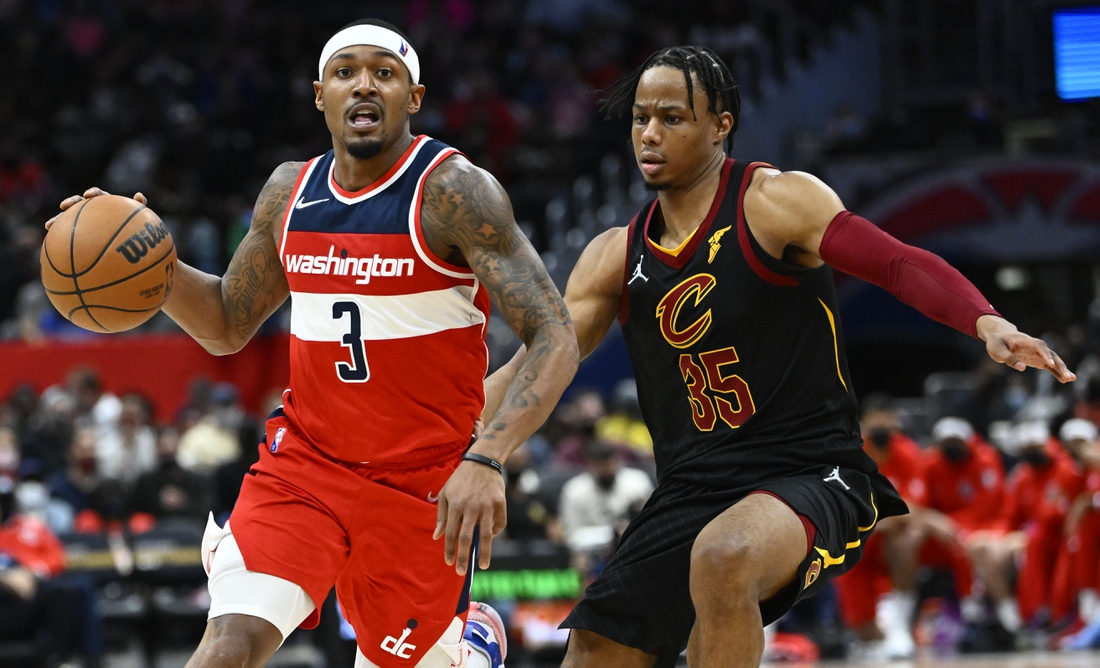 Dec 30, 2021; Washington, District of Columbia, USA; Washington Wizards guard Bradley Beal (3) dribbles past Cleveland Cavaliers forward Isaac Okoro (35) during the second half at Capital One Arena. Mandatory Credit: Brad Mills-USA TODAY Sports