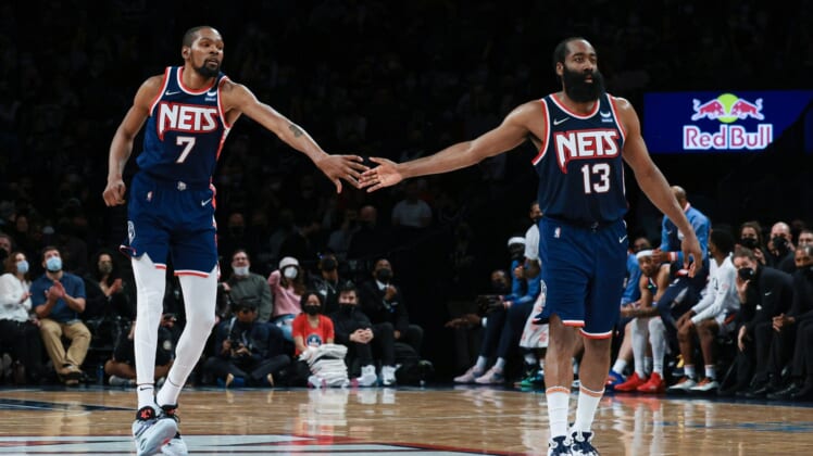 Dec 30, 2021; Brooklyn, New York, USA; Brooklyn Nets forward Kevin Durant (7) slaps hands with Brooklyn Nets guard James Harden (13) during the second half against the Philadelphia 76ers at Barclays Center. Mandatory Credit: Vincent Carchietta-USA TODAY Sports