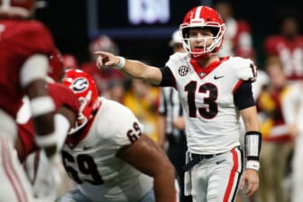 Georgia quarterback Stetson Bennett (13) gets set to run a play during the first half of the Southeastern Conference championship NCAA college football game between Georgia and Alabama in Atlanta, on Saturday, Dec. 4, 2021.News Joshua L JonesSyndication Online AthensSyndication Palm Beach Post