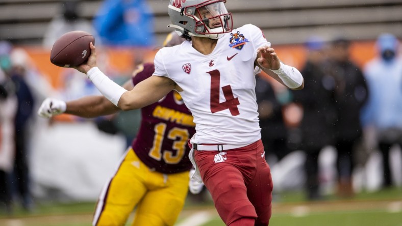 Dec 31, 2021; El Paso, Texas, USA; Washington State Cougars quarterback Jayden de Laura (4) drops back to pass the ball against the Central Michigan Chippewas defense in the 88th annual Sun Bowl football game at Sun Bowl Stadium. Mandatory Credit: Ivan Pierre Aguirre-USA TODAY Sports