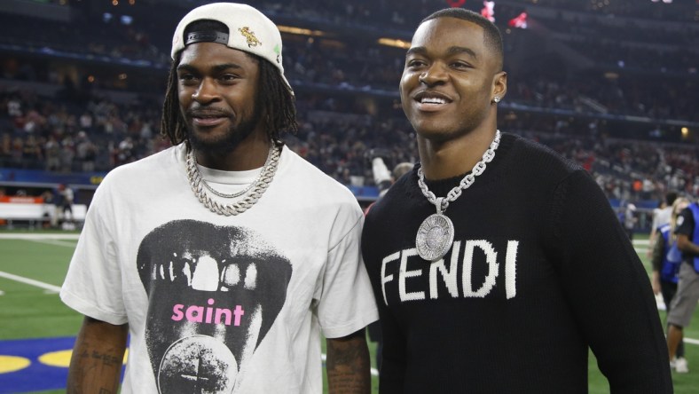 Dec 31, 2021; Arlington, Texas, USA; Dallas Cowboys Trevon Diggs (L) and Amari Cooper (R) pose on the field after the game against the Cincinnati Bearcats at the 2021 Cotton Bowl college football CFP national semifinal game at AT&T Stadium. Mandatory Credit: Tim Heitman-USA TODAY Sports