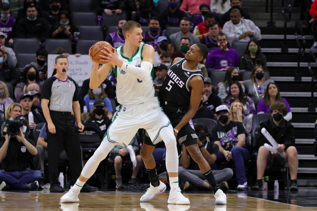 Dec 31, 2021; Sacramento, California, USA; Dallas Mavericks center Kristaps Porzingis (6) controls the ball against Sacramento Kings guard De'Aaron Fox (5) during the third quarter at Golden 1 Center. Mandatory Credit: Sergio Estrada-USA TODAY Sports