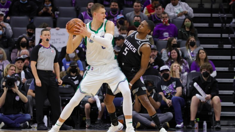 Dec 31, 2021; Sacramento, California, USA; Dallas Mavericks center Kristaps Porzingis (6) controls the ball against Sacramento Kings guard De'Aaron Fox (5) during the third quarter at Golden 1 Center. Mandatory Credit: Sergio Estrada-USA TODAY Sports