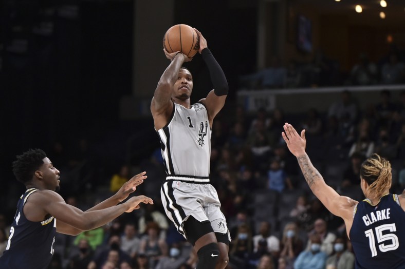 Dec 31, 2021; Memphis, Tennessee, USA; San Antonio Spurs guard Lonnie Walker IV (1) shoots the ball against Memphis Grizzlies forward Brandon Clarke (15) during the first half  at FedExForum. Mandatory Credit: Justin Ford-USA TODAY Sports