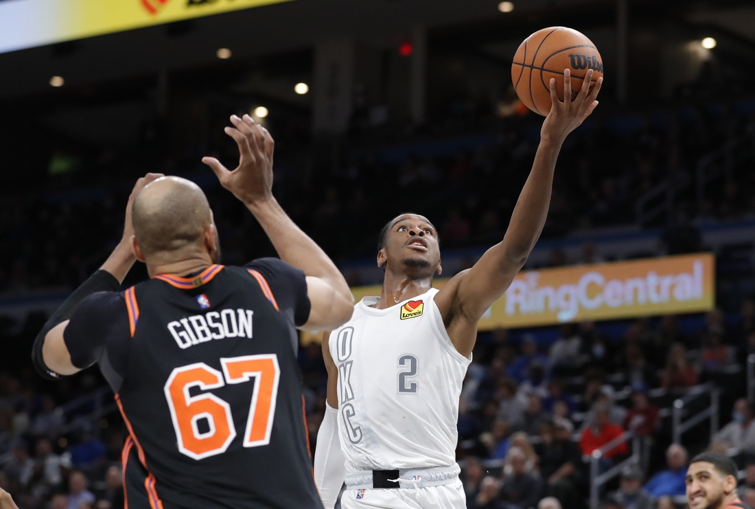 Dec 31, 2021; Oklahoma City, Oklahoma, USA; Oklahoma City Thunder guard Shai Gilgeous-Alexander (2) goes up for a basket in front of New York Knicks center Taj Gibson (67) during the second half at Paycom Center. Mandatory Credit: Alonzo Adams-USA TODAY Sports