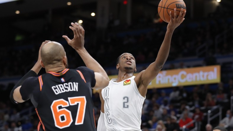 Dec 31, 2021; Oklahoma City, Oklahoma, USA; Oklahoma City Thunder guard Shai Gilgeous-Alexander (2) goes up for a basket in front of New York Knicks center Taj Gibson (67) during the second half at Paycom Center. Mandatory Credit: Alonzo Adams-USA TODAY Sports