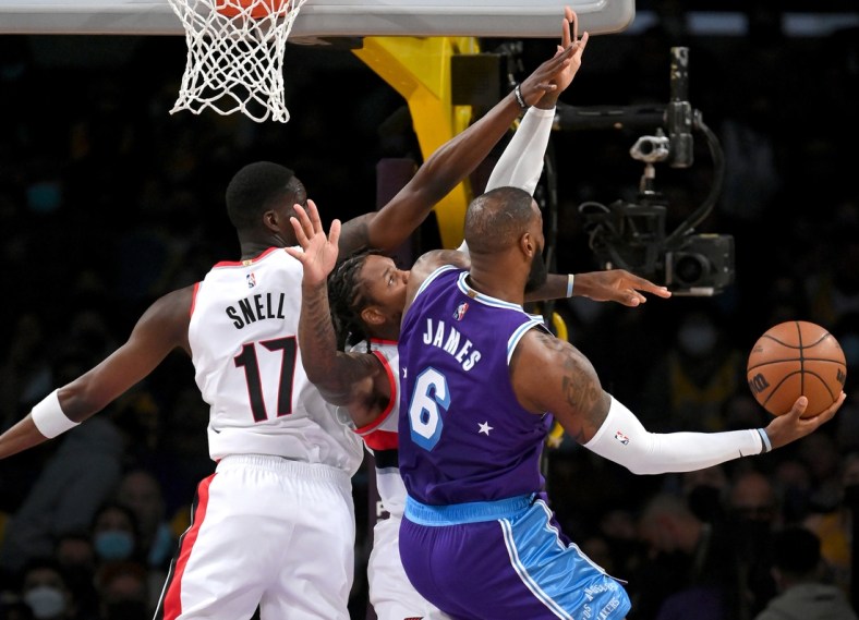 Dec 31, 2021; Los Angeles, California, USA; Los Angeles Lakers forward LeBron James (6) scores a basket past Portland Trail Blazers forward Tony Snell (17) and guard Ben McLemore (23) in the first quarter at Crypto.com Arena. Mandatory Credit: Jayne Kamin-Oncea-USA TODAY Sports