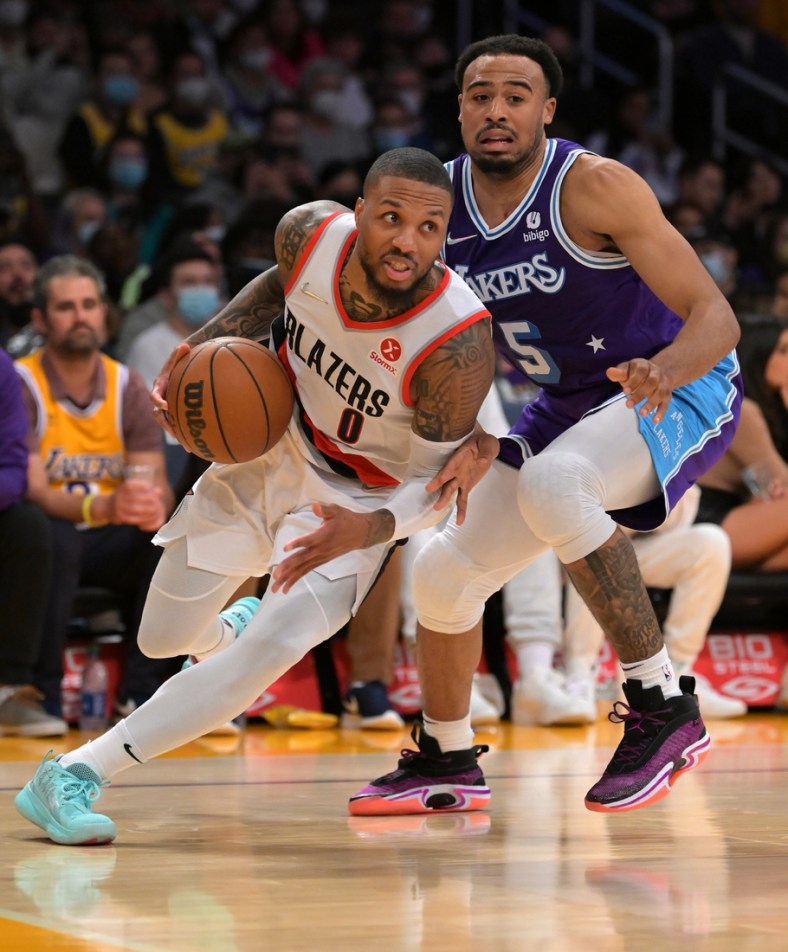 Dec 31, 2021; Los Angeles, California, USA; Portland Trail Blazers guard Damian Lillard (0) is defended by Los Angeles Lakers Talen Horton-Tucker (5) as he drives to the basket in the first half at Crypto.com Arena. Mandatory Credit: Jayne Kamin-Oncea-USA TODAY Sports