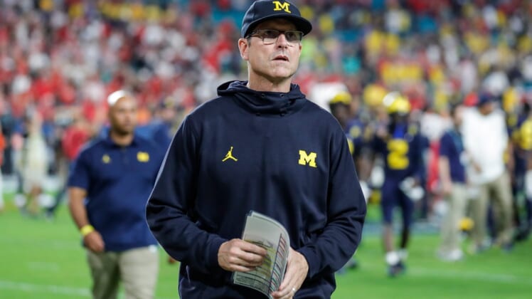 Michigan head coach Jim Harbaugh walks off the field after the Wolverines' 34-11 loss to the Georgia Bulldogs in the Orange Bowl.Syndication Detroit Free Press