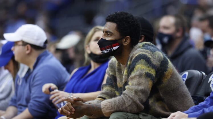 Jan 1, 2022; Newark, New Jersey, USA; Brooklyn Nets guard Kyrie Irving watches from the stands during the first half of the game between the Seton Hall Pirates and the Villanova Wildcats at Prudential Center. Mandatory Credit: Vincent Carchietta-USA TODAY Sports