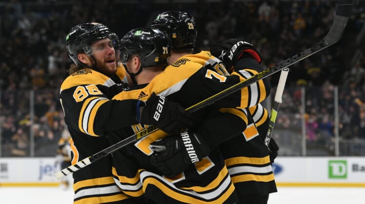 Jan 1, 2022; Boston, Massachusetts, USA; Boston Bruins left wing Taylor Hall (71) celebrates with right wing David Pastrnak (88) and defenseman Derek Forbort (28) after scoring against the Buffalo Sabres during the third period at TD Garden. Mandatory Credit: Brian Fluharty-USA TODAY Sports