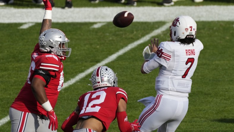 Jan 1, 2022; Pasadena, California, USA; Utah Utes quarterback Cameron Rising (7) gets off a pass pressured by Ohio State Buckeyes defensive tackle Jerron Cage (86) and Ohio State Buckeyes safety Lathan Ransom (12) during the first quarter of the 2022 Rose Bowl at Rose Bowl. Mandatory Credit: Robert Hanashiro-USA TODAY Sports