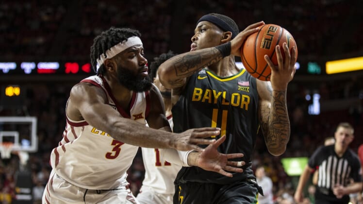 Jan 1, 2022; Ames, IA, USA; Baylor's James Akinjo looks for an open pass while Iowa State's Tre Jackson defends on Saturday Jan. 1, 2022, at Hilton Coliseum, in Ames. The Cyclones fell to the Bears 77-72.  Mandatory Credit: Kelsey Kremer-USA TODAY Sports