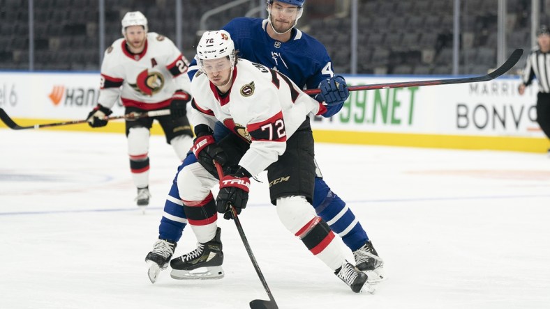 Jan 1, 2022; Toronto, Ontario, CAN; Toronto Maple Leafs left wing Pierre Engvall (47) battles for the puck with Ottawa Senators defenseman Thomas Chabot (72) during the first period at Scotiabank Arena. Mandatory Credit: Nick Turchiaro-USA TODAY Sports