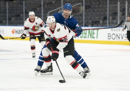 Jan 1, 2022; Toronto, Ontario, CAN; Toronto Maple Leafs left wing Pierre Engvall (47) battles for the puck with Ottawa Senators defenseman Thomas Chabot (72) during the first period at Scotiabank Arena. Mandatory Credit: Nick Turchiaro-USA TODAY Sports