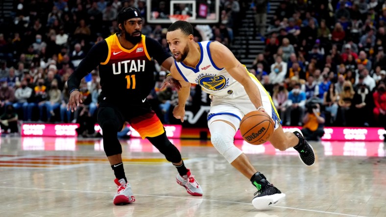 Jan 1, 2022; Salt Lake City, Utah, USA; Golden State Warriors guard Stephen Curry (30) drives past Utah Jazz guard Mike Conley (11) in the first half at Vivint Arena. Mandatory Credit: Ron Chenoy-USA TODAY Sports