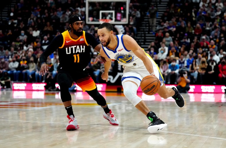 Jan 1, 2022; Salt Lake City, Utah, USA; Golden State Warriors guard Stephen Curry (30) drives past Utah Jazz guard Mike Conley (11) in the first half at Vivint Arena. Mandatory Credit: Ron Chenoy-USA TODAY Sports