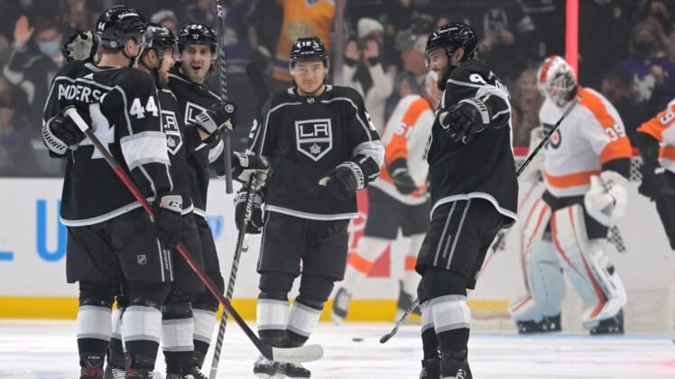 Jan 1, 2022; Los Angeles, California, USA;  Los Angeles Kings defenseman Mikey Anderson (44), center Phillip Danault (24), center Trevor Moore (12) and defenseman Drew Doughty (8) celebrate after a goal by left wing Viktor Arvidsson (33) in the first period of the game against the Philadelphia Flyers at Crypto.com Arena. Mandatory Credit: Jayne Kamin-Oncea-USA TODAY Sports