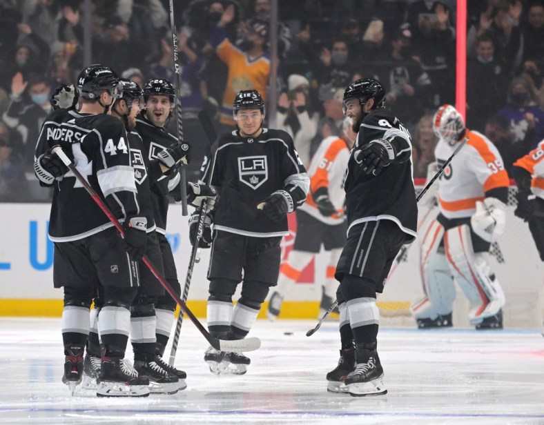 Jan 1, 2022; Los Angeles, California, USA;  Los Angeles Kings defenseman Mikey Anderson (44), center Phillip Danault (24), center Trevor Moore (12) and defenseman Drew Doughty (8) celebrate after a goal by left wing Viktor Arvidsson (33) in the first period of the game against the Philadelphia Flyers at Crypto.com Arena. Mandatory Credit: Jayne Kamin-Oncea-USA TODAY Sports
