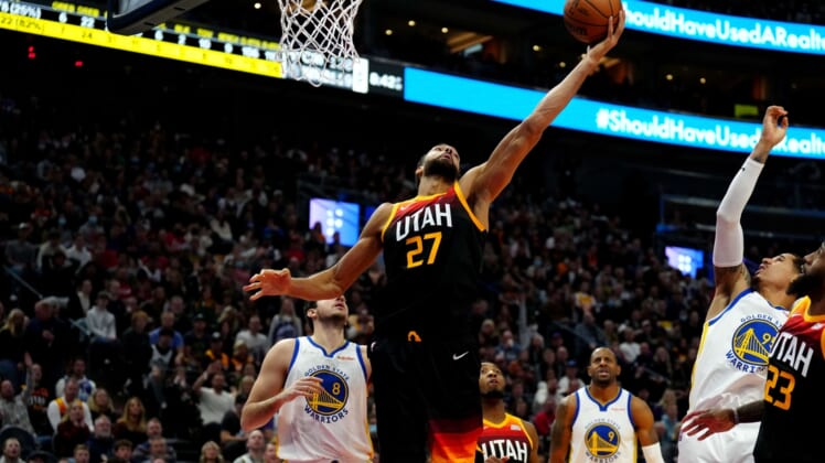 Jan 1, 2022; Salt Lake City, Utah, USA; Utah Jazz center Rudy Gobert (27) pulls in a rebound in the second half against the Golden State Warriors at Vivint Arena. Mandatory Credit: Ron Chenoy-USA TODAY Sports