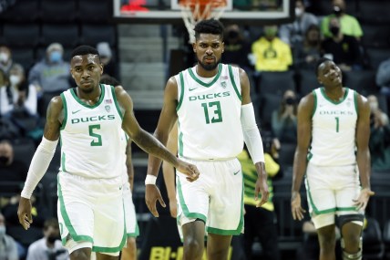 Jan 1, 2022; Eugene, Oregon, USA; Oregon Ducks guard De'Vion Harmon (5), forward Quincy Guerrier (13), and center N'Faly Dante (1) walk back to the court after a timeout against the Utah Utes during the second half at Matthew Knight Arena. Mandatory Credit: Soobum Im-USA TODAY Sports