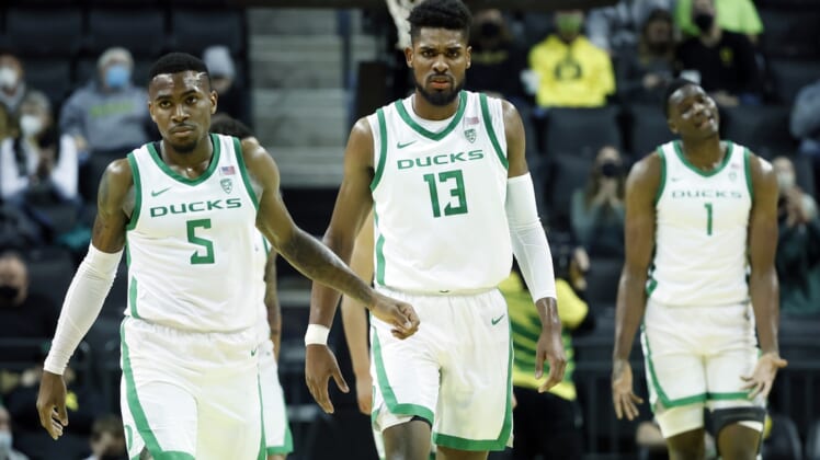 Jan 1, 2022; Eugene, Oregon, USA; Oregon Ducks guard De'Vion Harmon (5), forward Quincy Guerrier (13), and center N'Faly Dante (1) walk back to the court after a timeout against the Utah Utes during the second half at Matthew Knight Arena. Mandatory Credit: Soobum Im-USA TODAY Sports