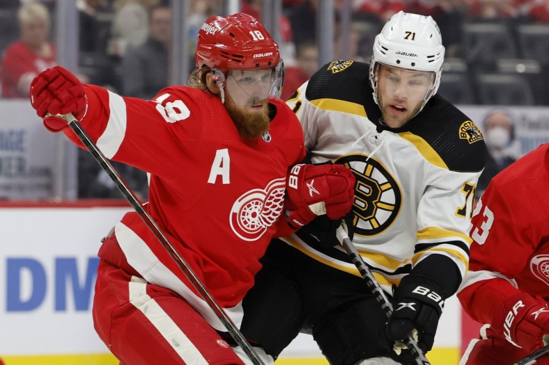 Jan 2, 2022; Detroit, Michigan, USA;  Detroit Red Wings defenseman Marc Staal (18) and Boston Bruins left wing Taylor Hall (71) fight for position in the first period at Little Caesars Arena. Mandatory Credit: Rick Osentoski-USA TODAY Sports