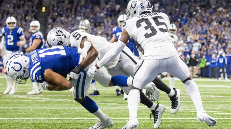 Jan 2, 2022; Indianapolis, Indiana, USA;  Indianapolis Colts wide receiver Michael Pittman (11) catches the ball and is stopped on the one yard line by Las Vegas Raiders linebacker Divine Deablo (5) in the first half at Lucas Oil Stadium. Mandatory Credit: Trevor Ruszkowski-USA TODAY Sports