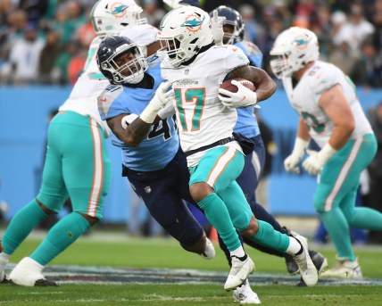 Jan 2, 2022; Nashville, Tennessee, USA; Miami Dolphins wide receiver Jaylen Waddle (17) fights off a tackle attempt from Tennessee Titans outside linebacker Zach Cunningham (41) during the first half at Nissan Stadium. Mandatory Credit: Christopher Hanewinckel-USA TODAY Sports