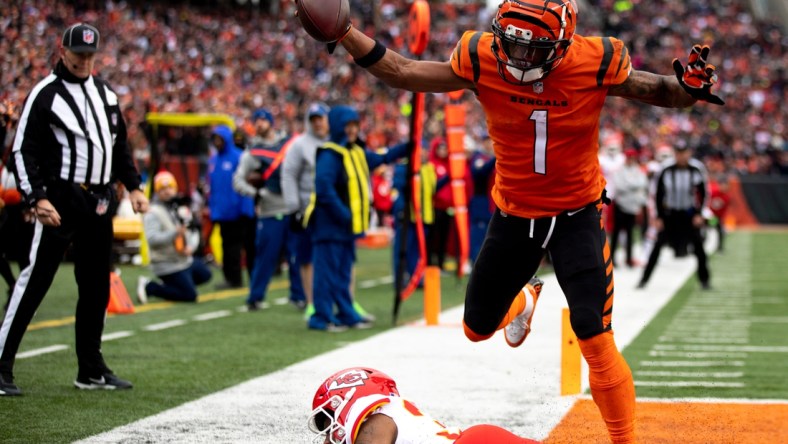 Cincinnati Bengals wide receiver Ja'Marr Chase (1) catches his second touchdown pass of the game from Cincinnati Bengals quarterback Joe Burrow (9) over Kansas City Chiefs cornerback Charvarius Ward (35) in the first half of the NFL game between the Cincinnati Bengals and the Kansas City Chiefs on Sunday, Jan. 2, 2022, at Paul Brown Stadium in Cincinnati.

Cincinnati Bengals And The Kansas City Chiefs 442