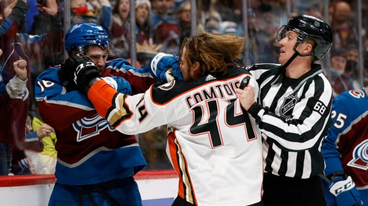 Jan 2, 2022; Denver, Colorado, USA; Colorado Avalanche right wing Nicolas Aube-Kubel (16) and Anaheim Ducks left wing Max Comtois (44) fight as linesman CJ Murray (68) intervenes in the second period at Ball Arena. Mandatory Credit: Isaiah J. Downing-USA TODAY Sports