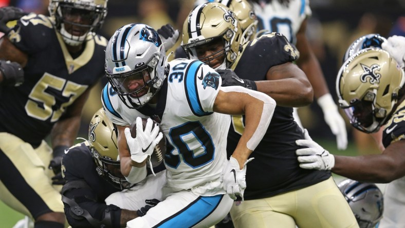 Jan 2, 2022; New Orleans, Louisiana, USA; Carolina Panthers running back Chuba Hubbard (30) is tackled by several New Orleans Saints defenders in the first quarter at the Caesars Superdome. Mandatory Credit: Chuck Cook-USA TODAY Sports