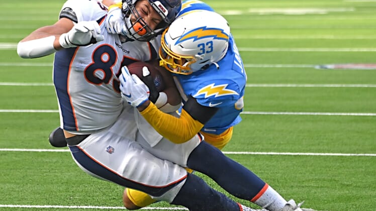 Jan 2, 2022; Inglewood, California, USA;  Denver Broncos tight end Andrew Beck (83) is taken down at the 3-yard line by Los Angeles Chargers free safety Derwin James (33) in the first half the game at SoFi Stadium. Mandatory Credit: Jayne Kamin-Oncea-USA TODAY Sports