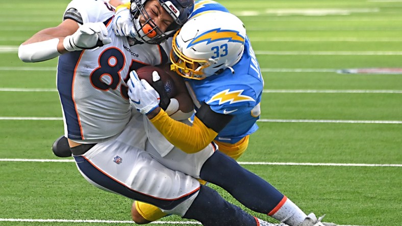 Jan 2, 2022; Inglewood, California, USA;  Denver Broncos tight end Andrew Beck (83) is taken down at the 3-yard line by Los Angeles Chargers free safety Derwin James (33) in the first half the game at SoFi Stadium. Mandatory Credit: Jayne Kamin-Oncea-USA TODAY Sports