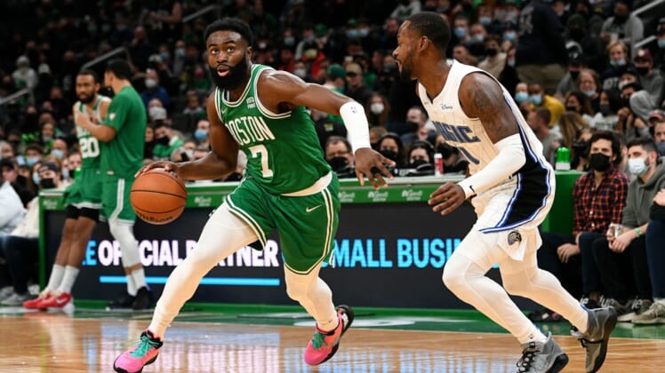 Jan 2, 2022; Boston, Massachusetts, USA; Boston Celtics guard Jaylen Brown (7) drives to the basket against Orlando Magic guard Terrence Ross (31) during the first half at the TD Garden. Mandatory Credit: Brian Fluharty-USA TODAY Sports