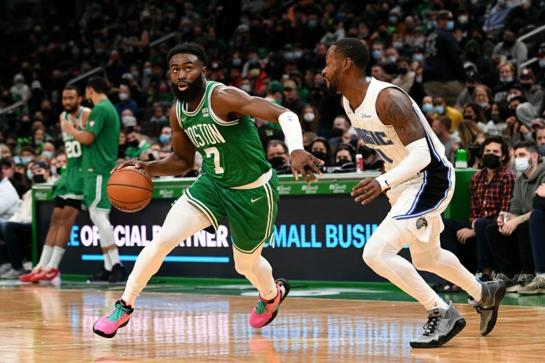 Jan 2, 2022; Boston, Massachusetts, USA; Boston Celtics guard Jaylen Brown (7) drives to the basket against Orlando Magic guard Terrence Ross (31) during the first half at the TD Garden. Mandatory Credit: Brian Fluharty-USA TODAY Sports