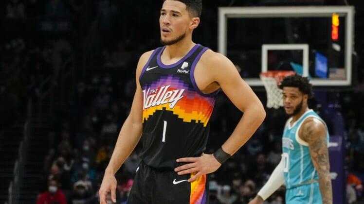Jan 2, 2022; Charlotte, North Carolina, USA; Phoenix Suns guard Devin Booker (1) looks on against the Charlotte Hornets during the first quarter at the Spectrum Center. Mandatory Credit: Jim Dedmon-USA TODAY Sports