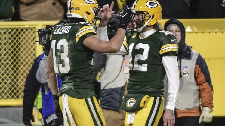 Jan 2, 2022; Green Bay, Wisconsin, USA; Green Bay Packers quarterback Aaron Rodgers (12) celebrates with wide receiver Allen Lazard (13) after a touchdown in the second quarter against the Minnesota Vikings at Lambeau Field. Mandatory Credit: Benny Sieu-USA TODAY Sports