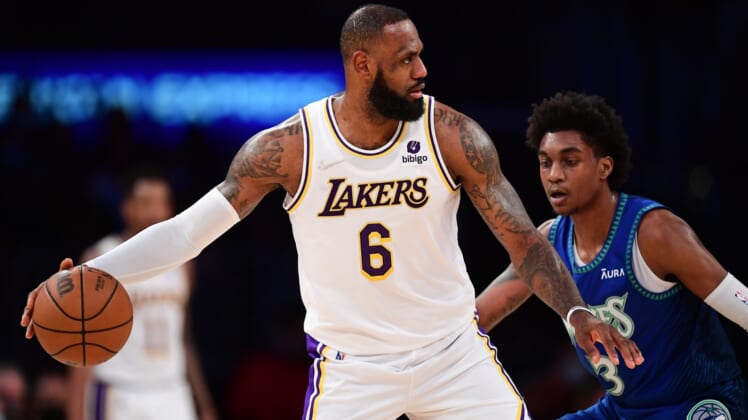 Jan 2, 2022; Los Angeles, California, USA; Los Angeles Lakers forward LeBron James (6) controls the ball in front of Minnesota Timberwolves forward Jaden McDaniels (3) during the first half at Crypto.com Arena. Mandatory Credit: Gary A. Vasquez-USA TODAY Sports