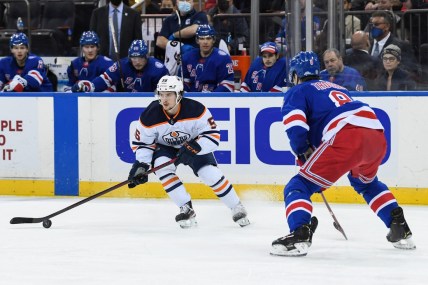 Jan 3, 2022; New York, New York, USA; Edmonton Oilers right wing Kailer Yamamoto (56) controls the puck defended by New York Rangers defenseman Jacob Trouba (8) during the first period at Madison Square Garden. Mandatory Credit: Dennis Schneidler-USA TODAY Sports