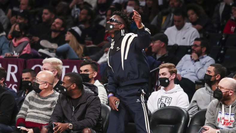 Jan 3, 2022; Brooklyn, New York, USA;  Former NFL wide receiver Antonio Brown cheers during the game between the Memphis Grizzlies and Brooklyn Nets at Barclays Center. Mandatory Credit: Wendell Cruz-USA TODAY Sports