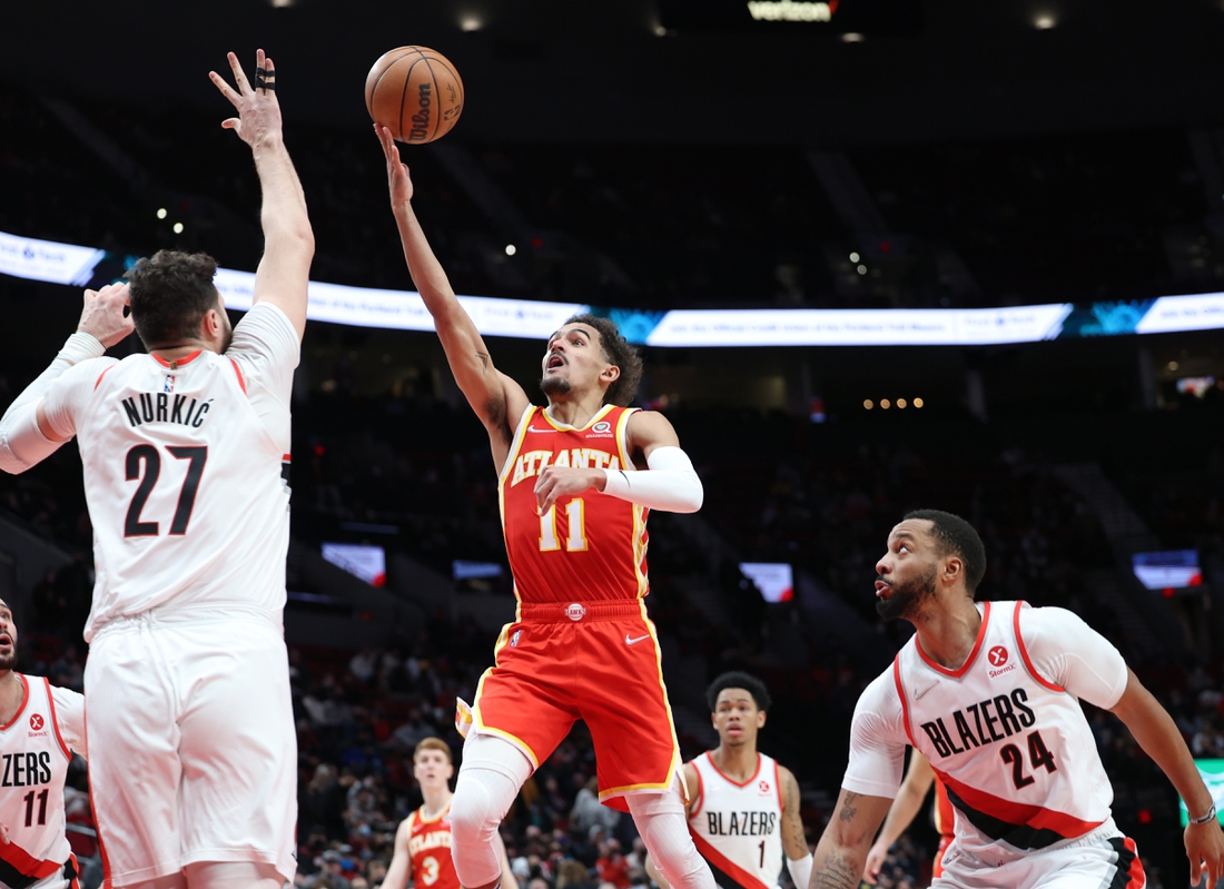 Jan 3, 2022; Portland, Oregon, USA;  Atlanta Hawks guard Trae Young (11) shoots over Portland Trail Blazers center Jusuf Nurkic (27) in the second half at Moda Center. Mandatory Credit: Jaime Valdez-USA TODAY Sports