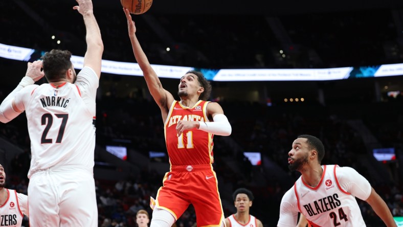 Jan 3, 2022; Portland, Oregon, USA;  Atlanta Hawks guard Trae Young (11) shoots over Portland Trail Blazers center Jusuf Nurkic (27) in the second half at Moda Center. Mandatory Credit: Jaime Valdez-USA TODAY Sports