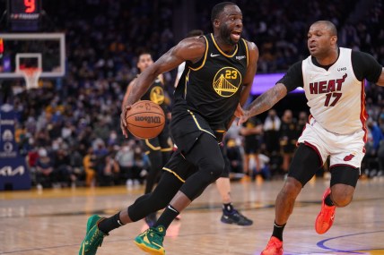 Jan 3, 2022; San Francisco, California, USA; Golden State Warriors forward Draymond Green (23) drives past Miami Heat forward P.J. Tucker (17) in the fourth quarter at the Chase Center. Mandatory Credit: Cary Edmondson-USA TODAY Sports