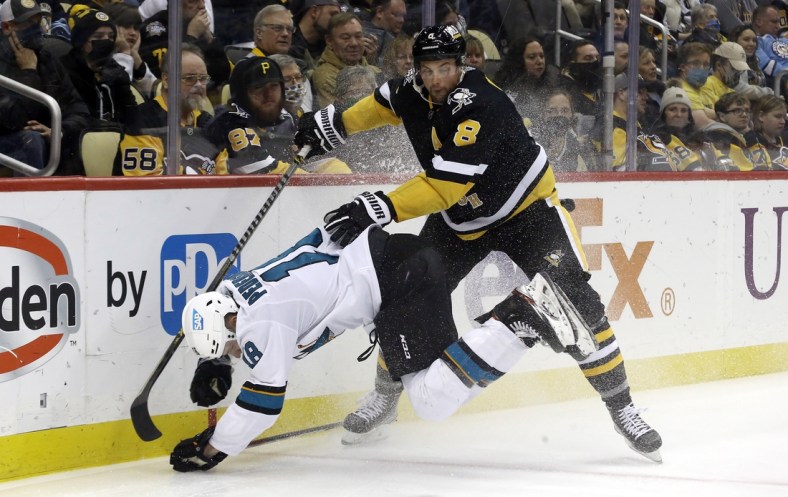 Jan 2, 2022; Pittsburgh, Pennsylvania, USA;  Pittsburgh Penguins defenseman Brian Dumoulin (8) checks San Jose Sharks center Lane Pederson (18) during the third period at PPG Paints Arena. Mandatory Credit: Charles LeClaire-USA TODAY Sports