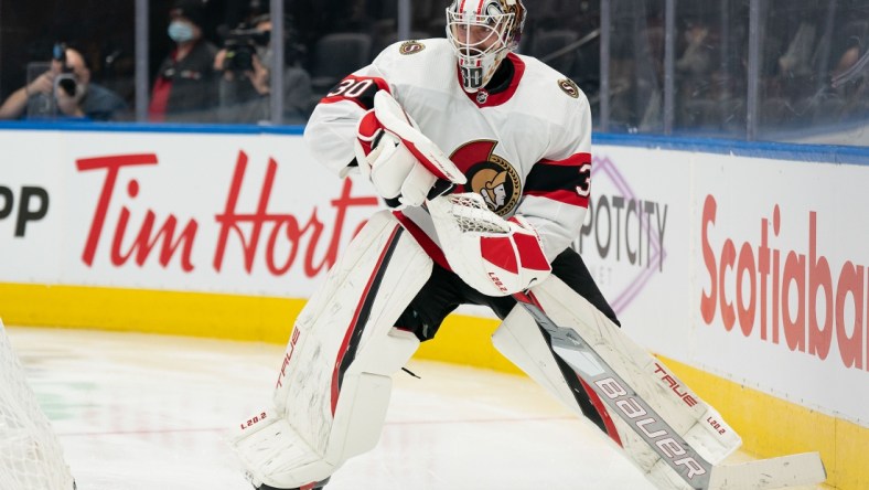 Jan 1, 2022; Toronto, Ontario, CAN; Ottawa Senators goaltender Matt Murray (30) handles the puck behind the net during the third period against the Toronto Maple Leafs at Scotiabank Arena. Mandatory Credit: Nick Turchiaro-USA TODAY Sports