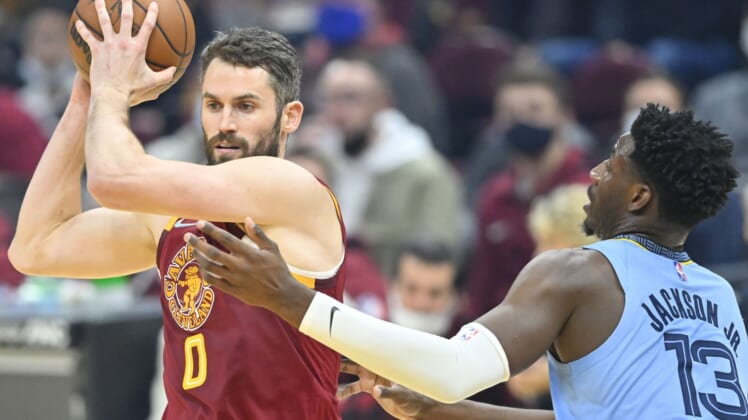 Jan 4, 2022; Cleveland, Ohio, USA; Memphis Grizzlies forward Jaren Jackson Jr. (13) defends Cleveland Cavaliers forward Kevin Love (0) in the first quarter at Rocket Mortgage FieldHouse. Mandatory Credit: David Richard-USA TODAY Sports